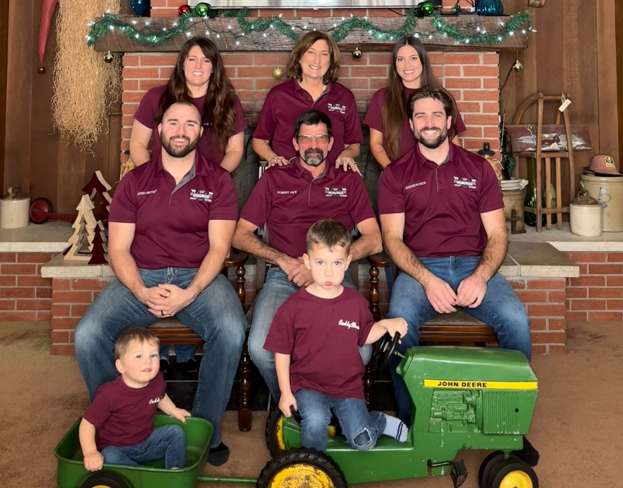 The CaddyShack family wearing matching maroon shirts